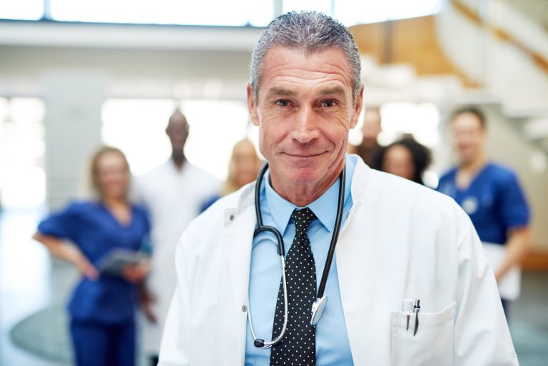 Portrait of adult cheerful doctor in hospital